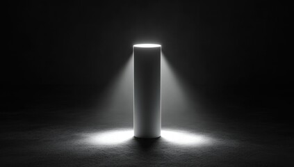 Sleek white cylinder illuminated by spotlight in dark studio