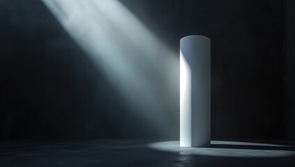 A solitary white cylinder, bathed in dramatic light, casts a spotlight in a dark room