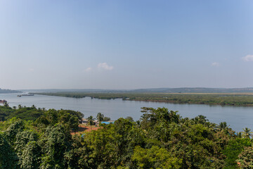 Expansive Goan river landscape with lush trees