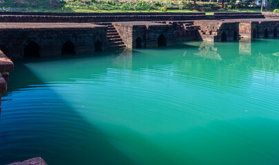 Ancient ruins reflected in a still blue pool