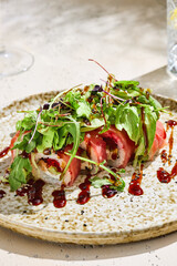Baked camembert with berry sauce and cracker, bright lighting, overhead composition