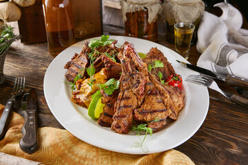 Grilled game meat assortment with venison rack, rustic warm lighting, overhead table composition