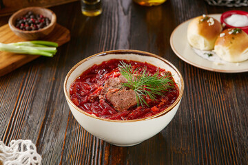 Wild game meat borscht in bright rustic lighting, overhead composition, garnished with dill