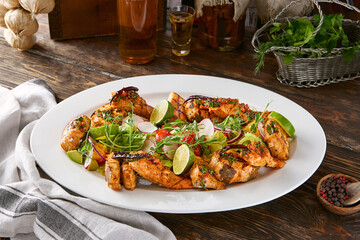 Grilled fish assortment, moody lighting, overhead composition with rustic wooden table