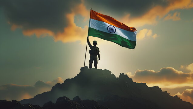 Silhouette of an Indian army soldier holding the flag of India on a mountain top