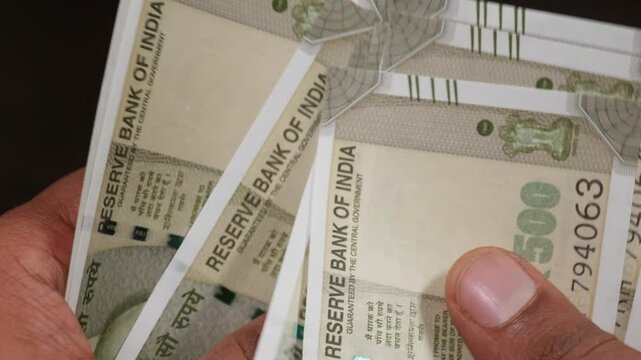 close up shot of indian currency new 500 rupees notes counting in black background. stable shot, 4k.