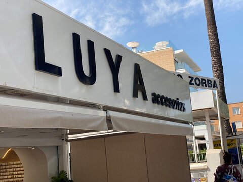 Palmanova, Spain - June 17, 2025: LUYA accessories storefront sign in vibrant urban setting, showcasing modern retail design and inviting atmosphere for shoppers