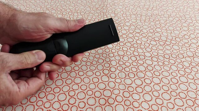Effortless control at your fingertips-explore the sleek black remote in action. Precision-crafted for seamless navigation, designed for comfort and intuitive use