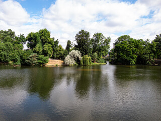 View to lake, trees and clouds in park
