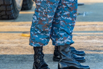 Soldiers in military uniforms wear military combat boots.