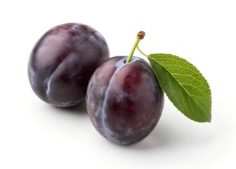 Two prune plums with green leaf on white background.