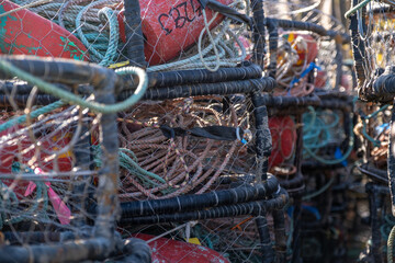 Close-up of tangled fishing lines and netting inside stacked crab pots at Bodega Bay, California,...