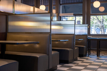 Booth seating inside a restaurant with natural light, checkerboard tile, and pendant lighting, San Francisco, CA, September 27, 2020