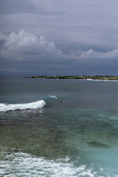 Surfers waiting under clouded skies