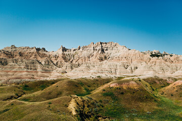 Green hills and Badlands National Park landscape