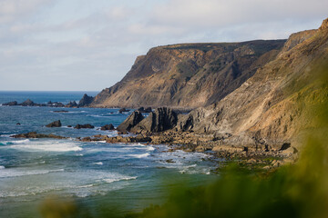 Stunning coastline cliffs and waves crashing on rocks in algarve