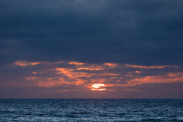 Sun setting over the atlantic ocean in algarve, portugal