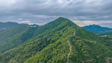 May 24 2025 View of a Lush Mountain Range Under a Cloudy Sky