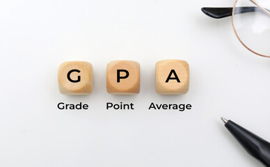 Wooden square with the letters GPA or the word grade point average