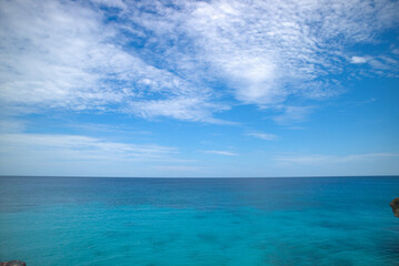 Clear Blue Ocean with Bright Sky and White Clouds on a Sunny Day