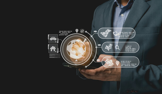 Businessman holding a digital device showcasing innovative technology with abstract icons and data visualization, representing modern analytics and connectivity