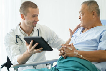 Obraz premium happy asian elderly looking at a good result of health check up in the medical chart with doctor.