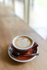 latte-art-coffee-cup-on-wooden-table.