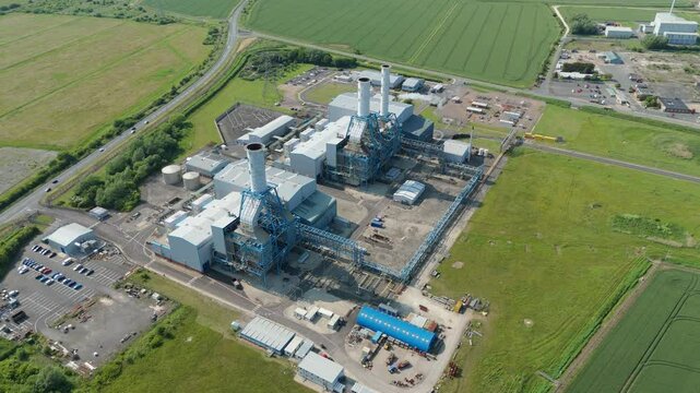 Aerial drone view of Power Station Humber South Bank near Immingham energy park electricity generation in England UK smoke stacks cooling towers with rural green fields nuclear gas coal oil fuel