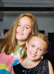 The portrait of two teenage girls. Having a good time at a party