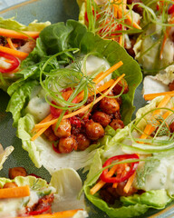 Chickpeas in lettuce leaf with yogurt