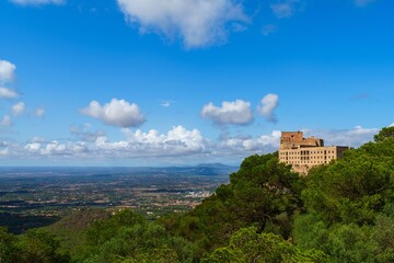 Naklejka premium Discover Santueri Castle in Mallorca, Spain. This stunning site showcases historical architecture and breathtaking views, embodying the rich heritage of mallorica.