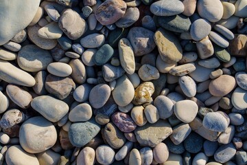 A close-up reveals a diverse collection of smooth, colorful pebbles in various sizes. This serene composition evokes tranquility and organic beauty, perfect for backgrounds and creative projects.