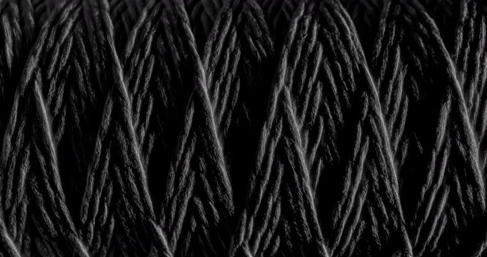 Seamless Woven Texture Background Loop. Texture of Dark rough twine. Video presenting a continuous dark gray woven thread texture, perfect for modern design applications