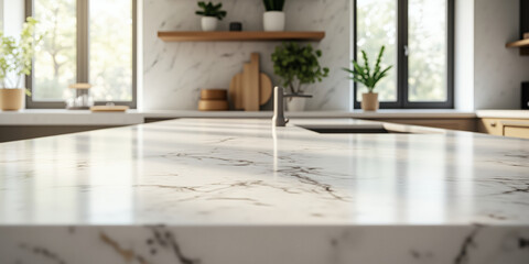 A close-up shot of a white marble kitchen countertop with subtle gold veins, showcasing a blurred background of a modern kitchen with a sink, wooden shelves, and green plants for home interior design.