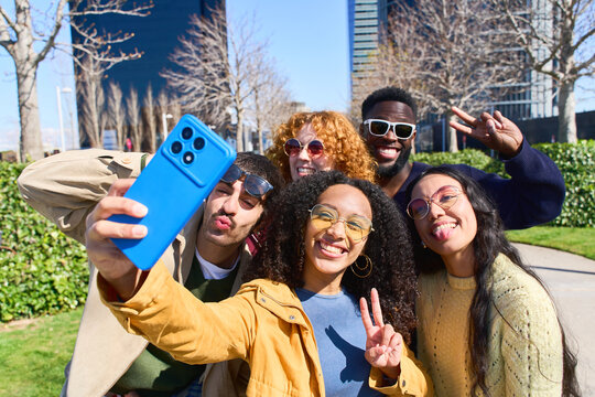 Group of diverse friends taking a selfie outdoors, embracing urban lifestyle