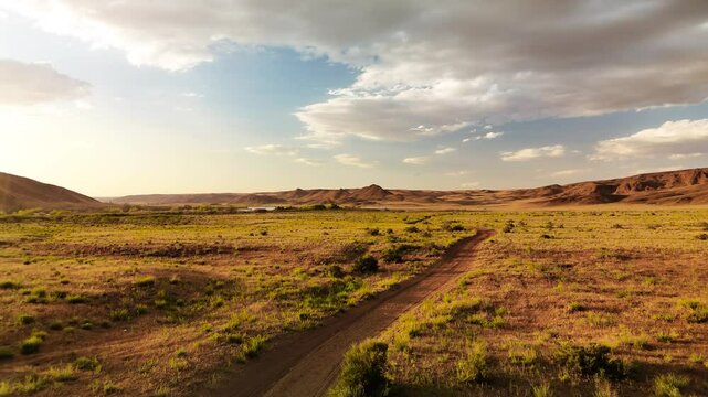 Drone shot of country road at spring steppe in Kazakhstan