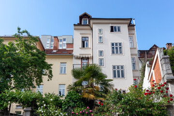 Fototapeta premium A charming architectural composition of residential buildings in Ljubljana, bathed in the clear light of a sunny day with a bright blue sky