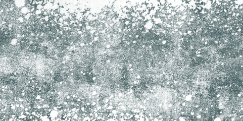 Abstract splattered white and gray grunge texture with dense speckles, smudges, and rough paint splatter effect background. Weathered look reminiscent of concrete walls or snowy patterns. 