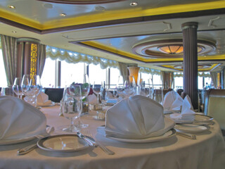 Formal and elegant ocean view dining room restaurant onboard luxury cruiseship or cruise ship liner...