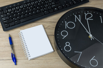 The concept of urgent deadline at work. Keyboard, clock, pen and blank paper