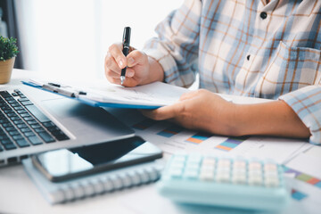 Woman calculating monthly home expenses, taxes, bank account balance and credit card bills payment,...