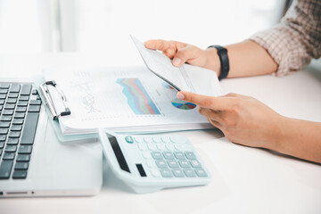 Business hands holding saving account passbook with calculator, account and saving concept. finance...