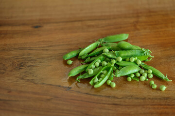 Green peas on a wooden table. High quality photo
