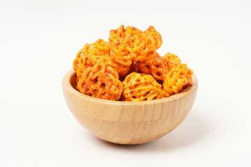 A pile of spicy Indonesian crackers or Kerupuk with spiral twists, coated in red-orange chili powder and rich spices. Bold, flavorful, and appetite-boosting. Photographed against a white background.