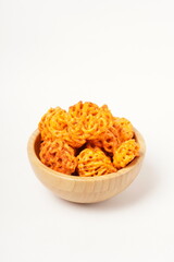 A pile of spicy Indonesian crackers or Kerupuk with spiral twists, coated in red-orange chili powder and rich spices. Bold, flavorful, and appetite-boosting. Photographed against a white background.