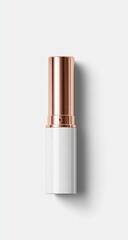 Obraz premium Rose gold-topped white cylindrical lipstick tube on white background, showing subtle shadow