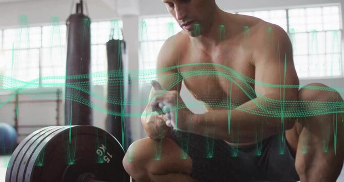 Shirtless athlete scooping chalk and rubbing hands in gym as green waveform tracking deadlift prep
