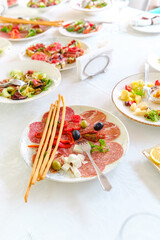 Delicious spread of fresh salads and cured meats at a summer gathering