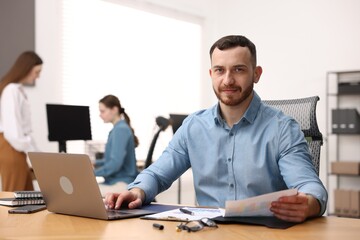Fototapeta premium Handsome man working at desk in office
