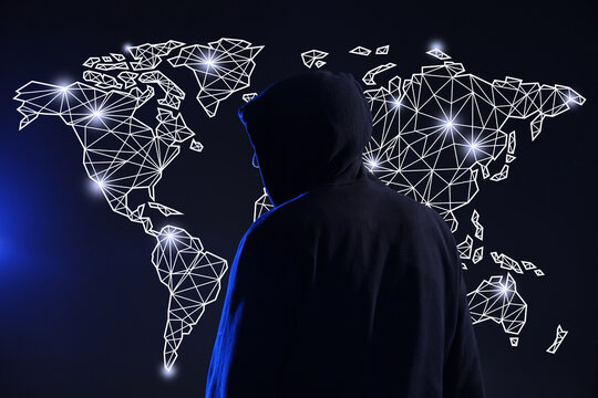 Cyber attack. Anonymous hacker in front of virtual screen with digital world map